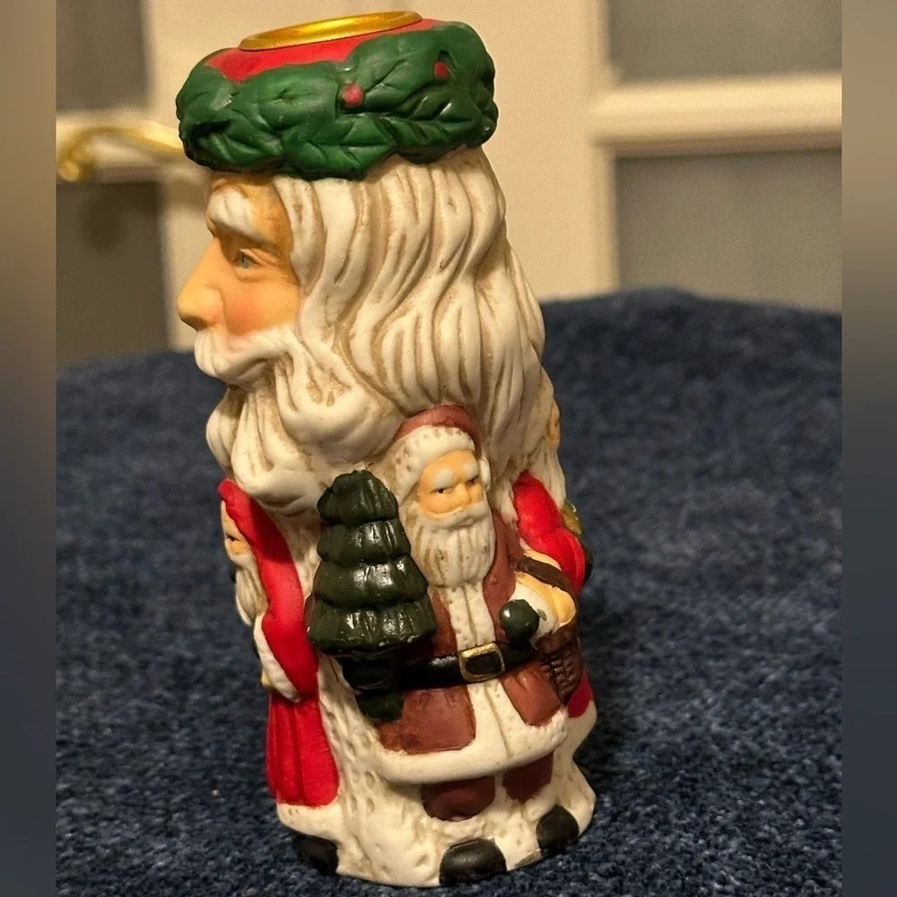 Set of 2 Santa candleholders. Each has smaller different smaller Santas.